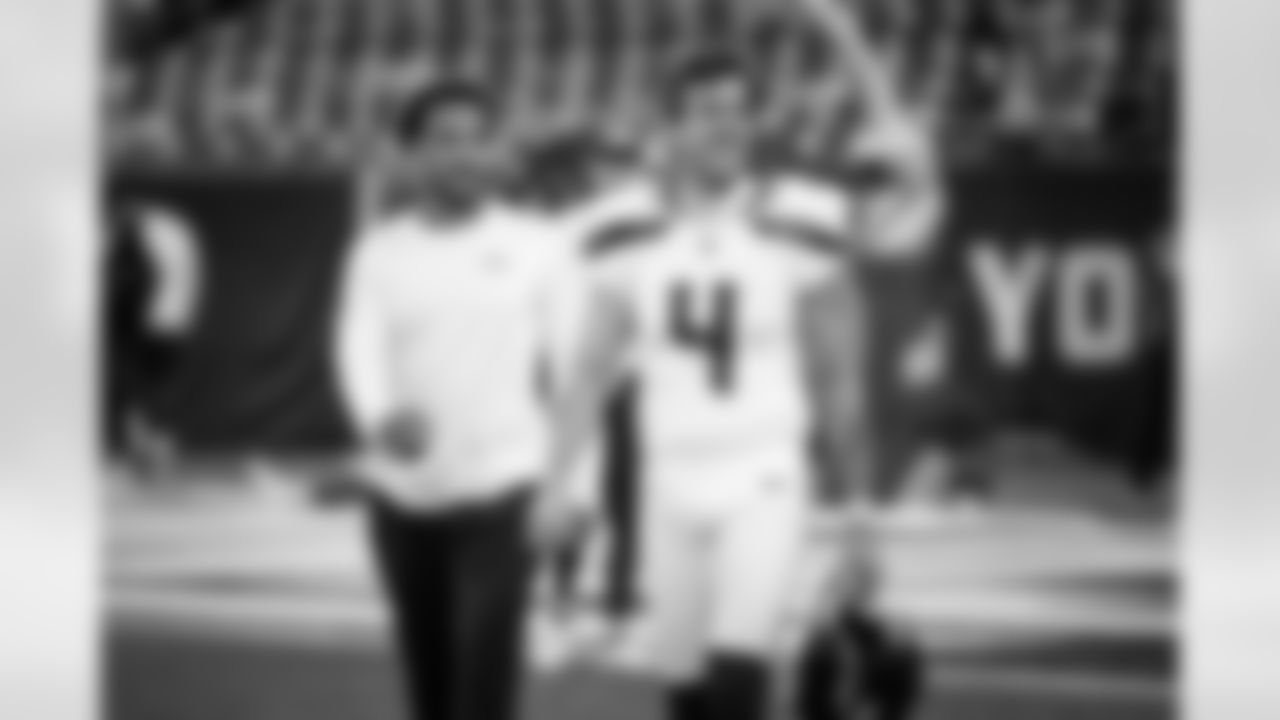 Punter Michael Dickson and receiver Cade Johnson smile as they walk across the field during early pregame.