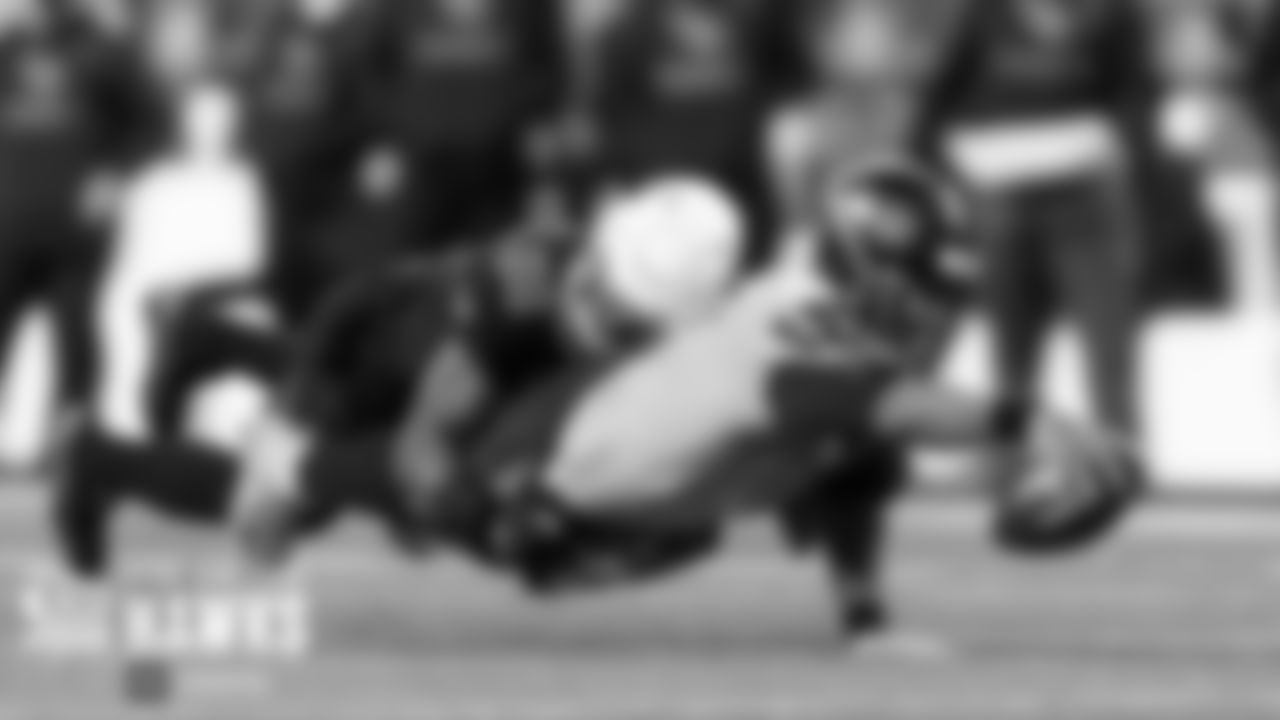 Seahawks quarterback Russell Wilson stretches for yardage in the first quarter.