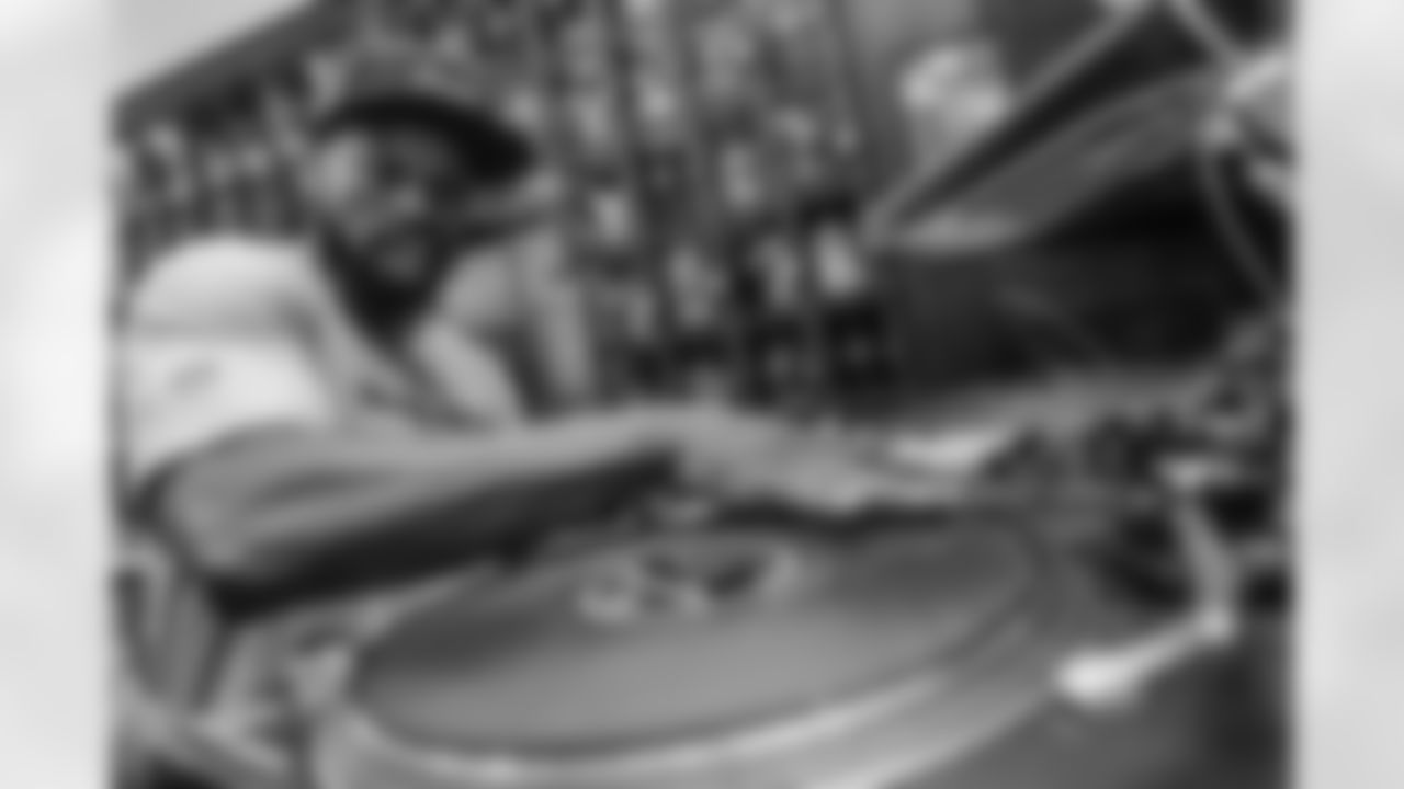 DJ SupaSam behind the turntable during the Seattle Seahawks Pub Event at the Augustiner Stammhaus pub, on Saturday, Nov. 12 2022 in Munich. (AP Photo/Omer Messinger)