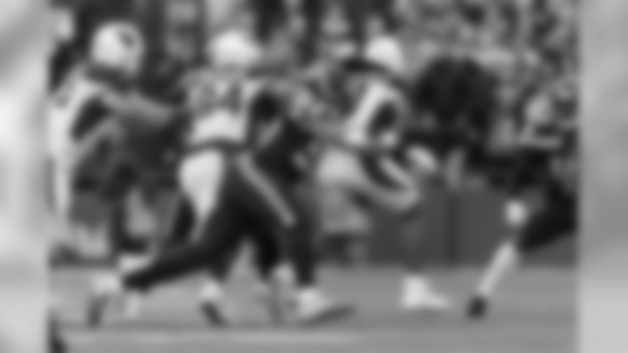 Seattle's K.J. Wright corrals Arizona receiver Larry Fitzgerald during the first quarter.