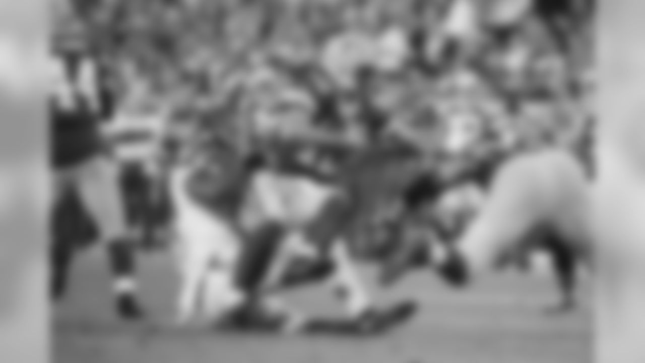 Seattle's Bruce Irvin takes down Green Bay's Aaron Rodgers for a sack.