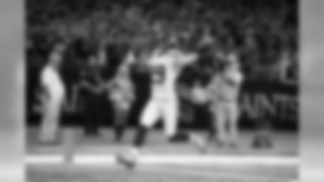 Safety Earl Thomas celebrates as he crosses the goal line with the game's opening touchdown. In the stands, a sea of 12s can be seen cheering as many Seahawks fans made the trip to New Orleans.