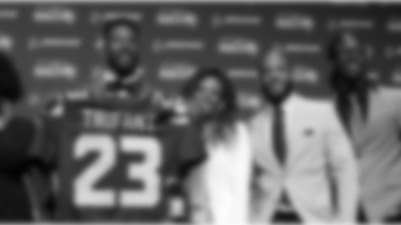 Seattle Seahawks' Marcus Trufant, left, holds up a team jersey as he stands with his wife Jessica and brothers Isaiah, second right, and Desmond to start a news conference announcing his retirement from football after signing with the team a day earlier, Thursday, April 24, 2014, in Renton, Wash. Trufant started 125 games in a Seattle career that lasted from 2003 to 2012. The cornerback was a first-round pick in 2003 out of Washington State and immediately moved into the starting lineup, playing a key role on the 2005 team that advanced to the franchise's first Super Bowl. (AP Photo/Elaine Thompson)