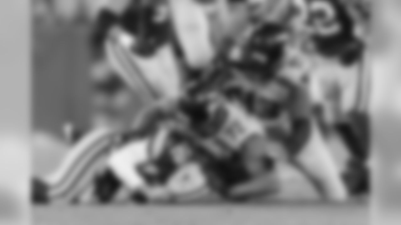 Seattle's Michael Bennett brings down Green Bay quarterback Aaron Rodgers in the third quarter.
