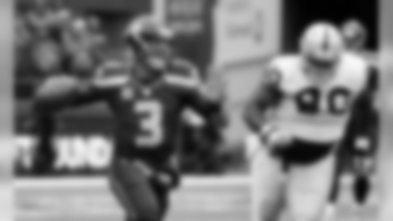Seattle Seahawks quarterback Russell Wilson (3) is chased by Oakland Raiders' Pat Sims in the first half of an NFL football game, Sunday, Nov. 2, 2014, in Seattle. (AP Photo/Elaine Thompson)