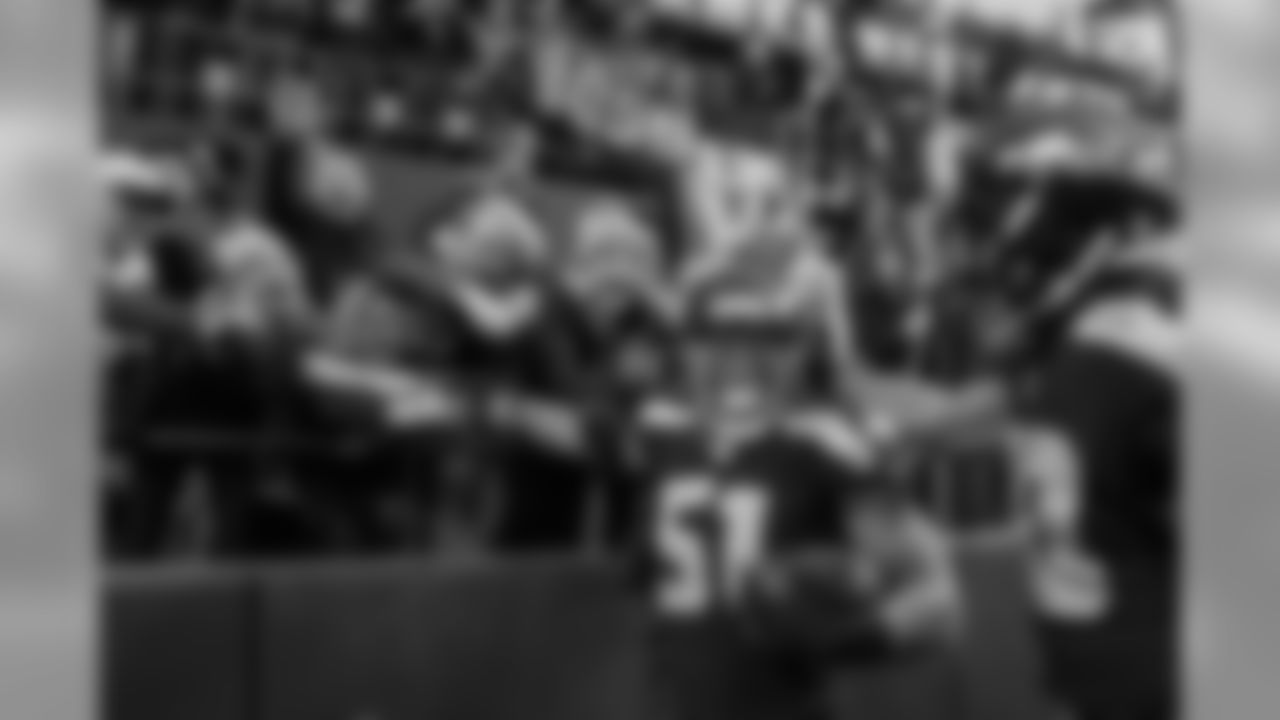 Bruce Irvin celebrates with fans in the Red Zone suites at the north end of the stadium after his 49-yard interception return for touchdown in the fourth quarter.