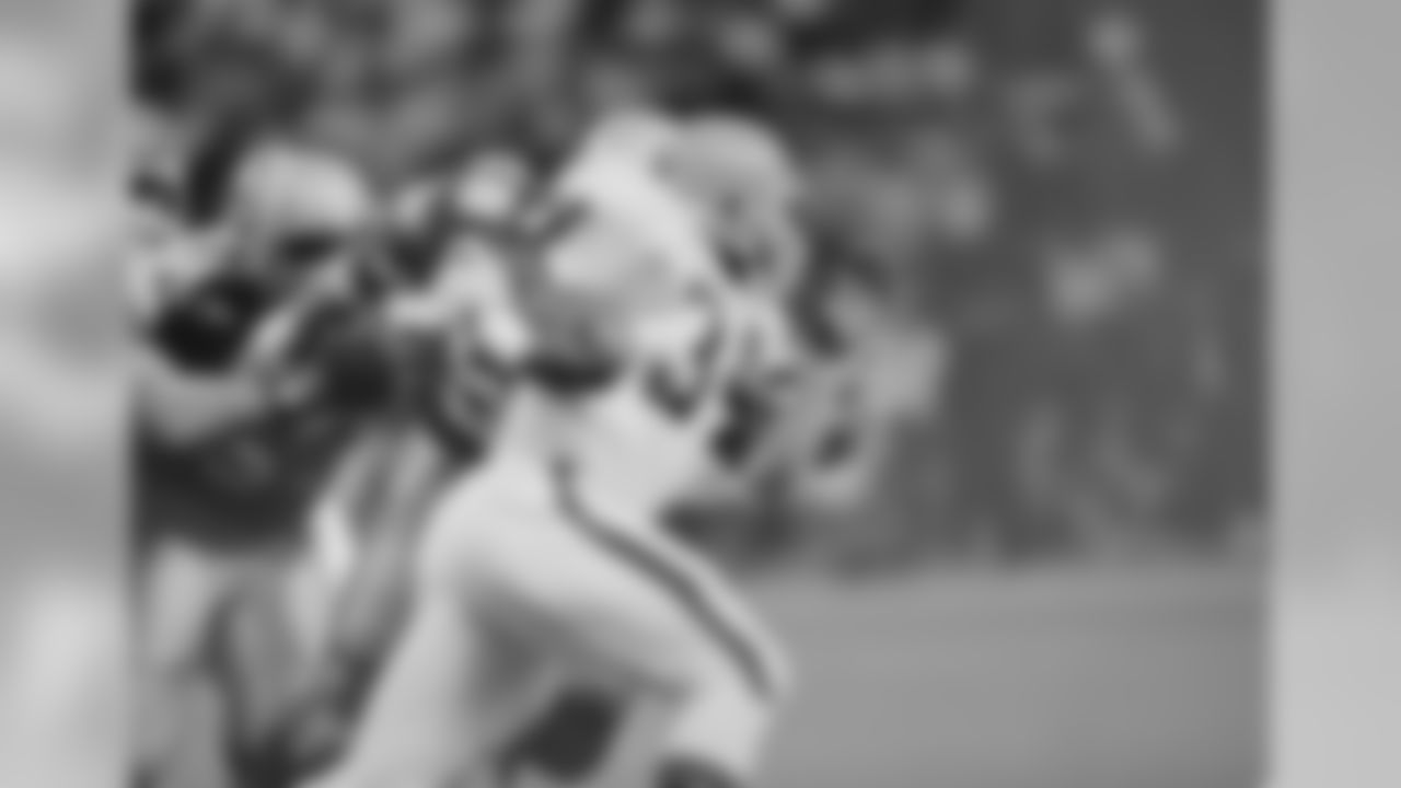 Kevin Mack of the Cleveland Browns (34) breaks through the Seattle Seahawk defense during the first quarter of game in the Kingdome in Seattle, Wash., Dec. 9, 1985. (AP Photo/Jerry Gay)