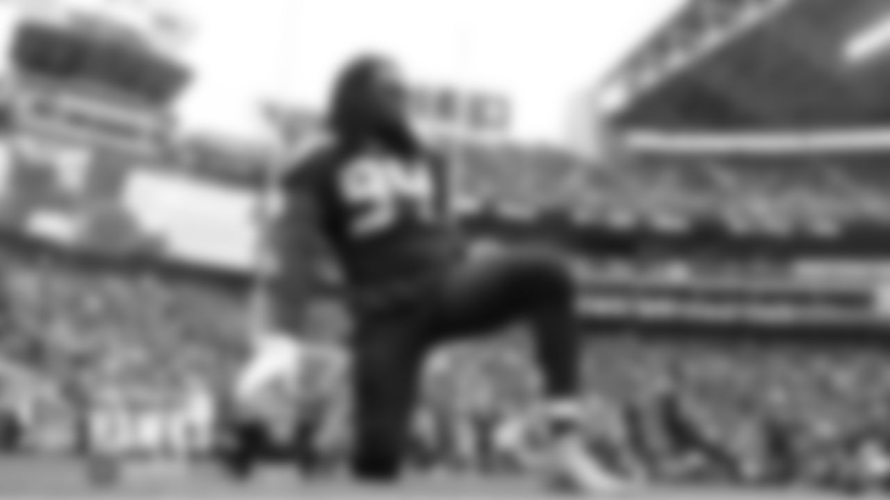 Seahawks defensive end Ziggy Ansah stretches before his first appearance of the season.