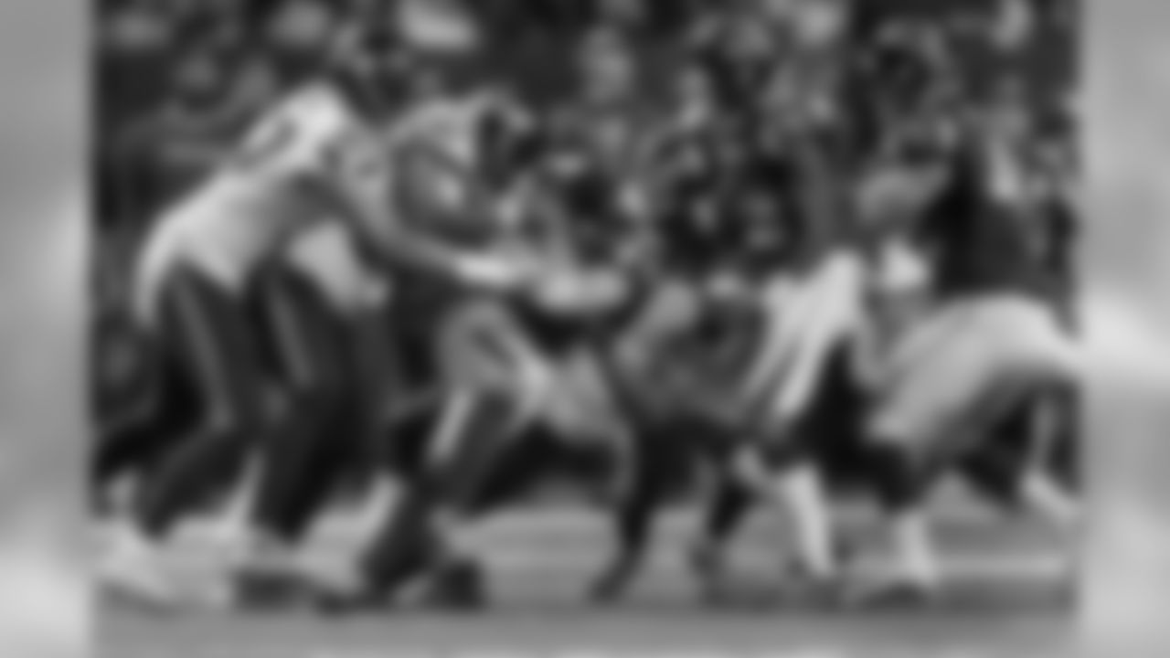 Seahawks defenders including Mike Morgan, Jeron Johnson and Kam Chancellor make a tackle in the first half.