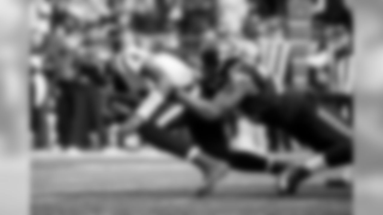 Michael Bennett brings down Houston quarterback Deshaun Watson.