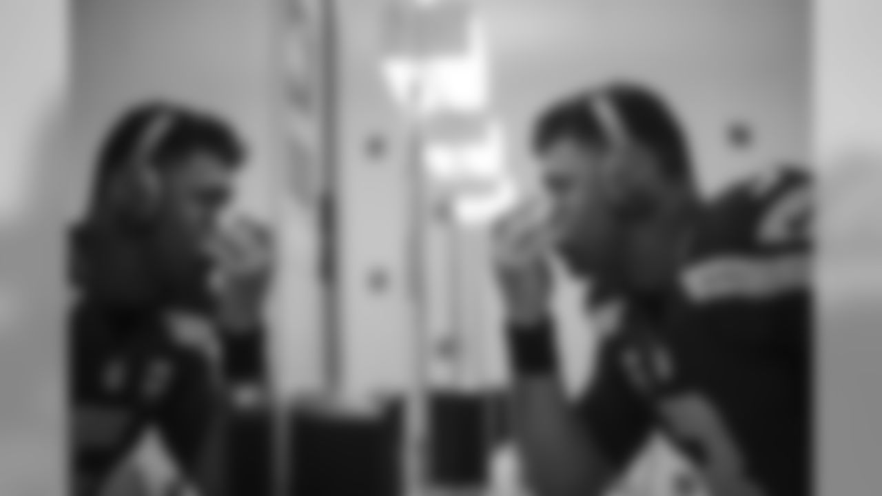 Russell Wilson applies eye black in the locker room before facing the St. Louis Rams in the final home game of the season.