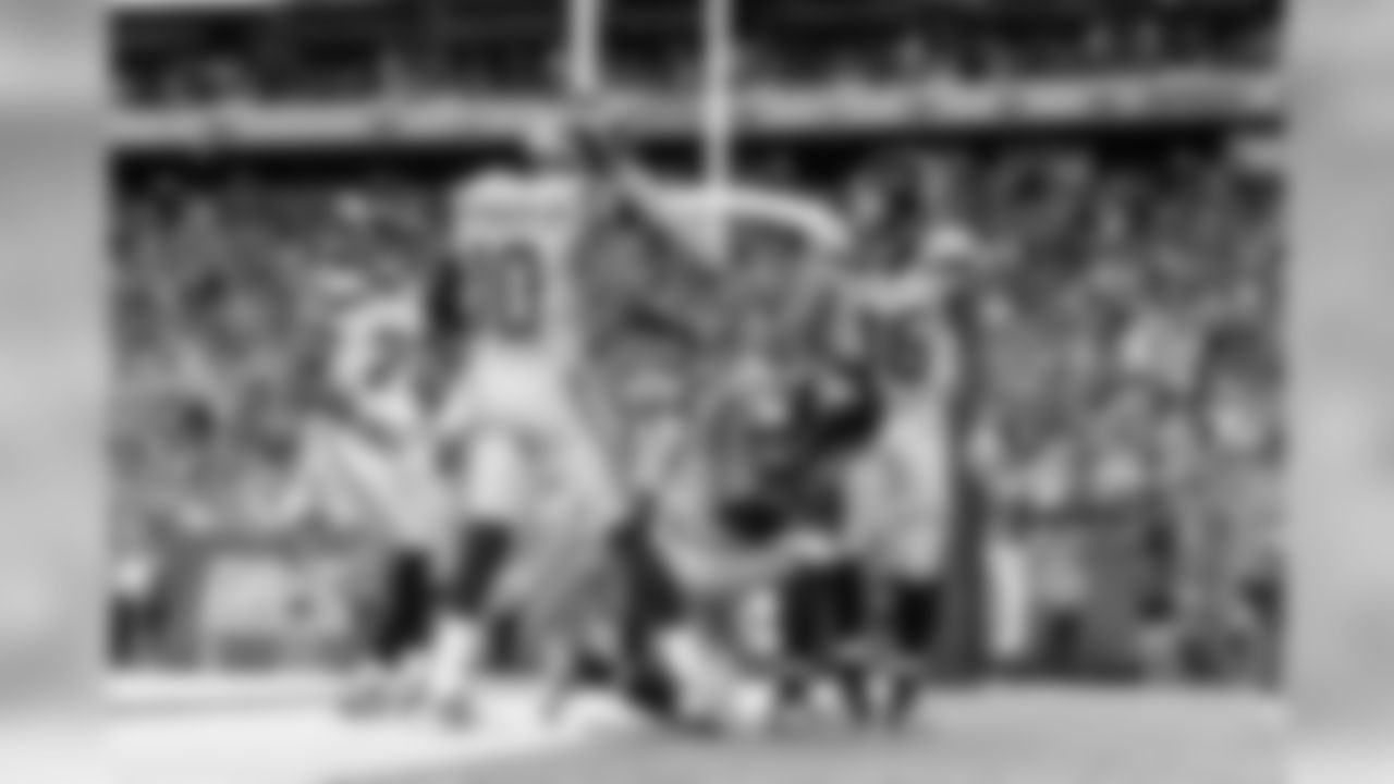 Doug Baldwin kneels after his touchdown surrounded by teammates Paul Richardson, J.D. McKissic and Tyler Lockett.