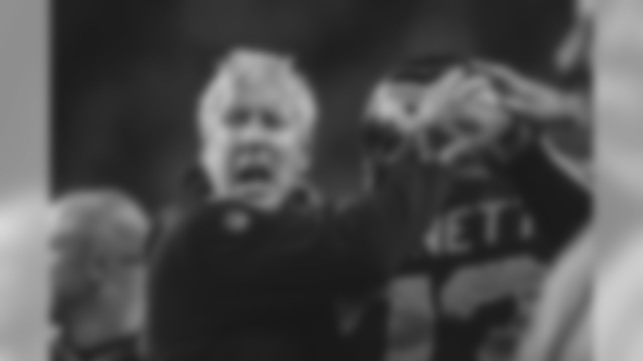 A fired-up Pete Carroll celebrates the turnover with defensive lineman Michael Bennett.