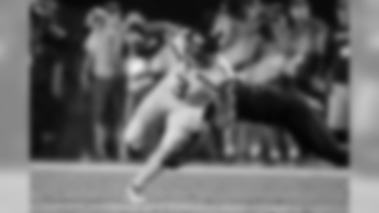 Seahawks quarterback Russell Wilson escapes pressure.