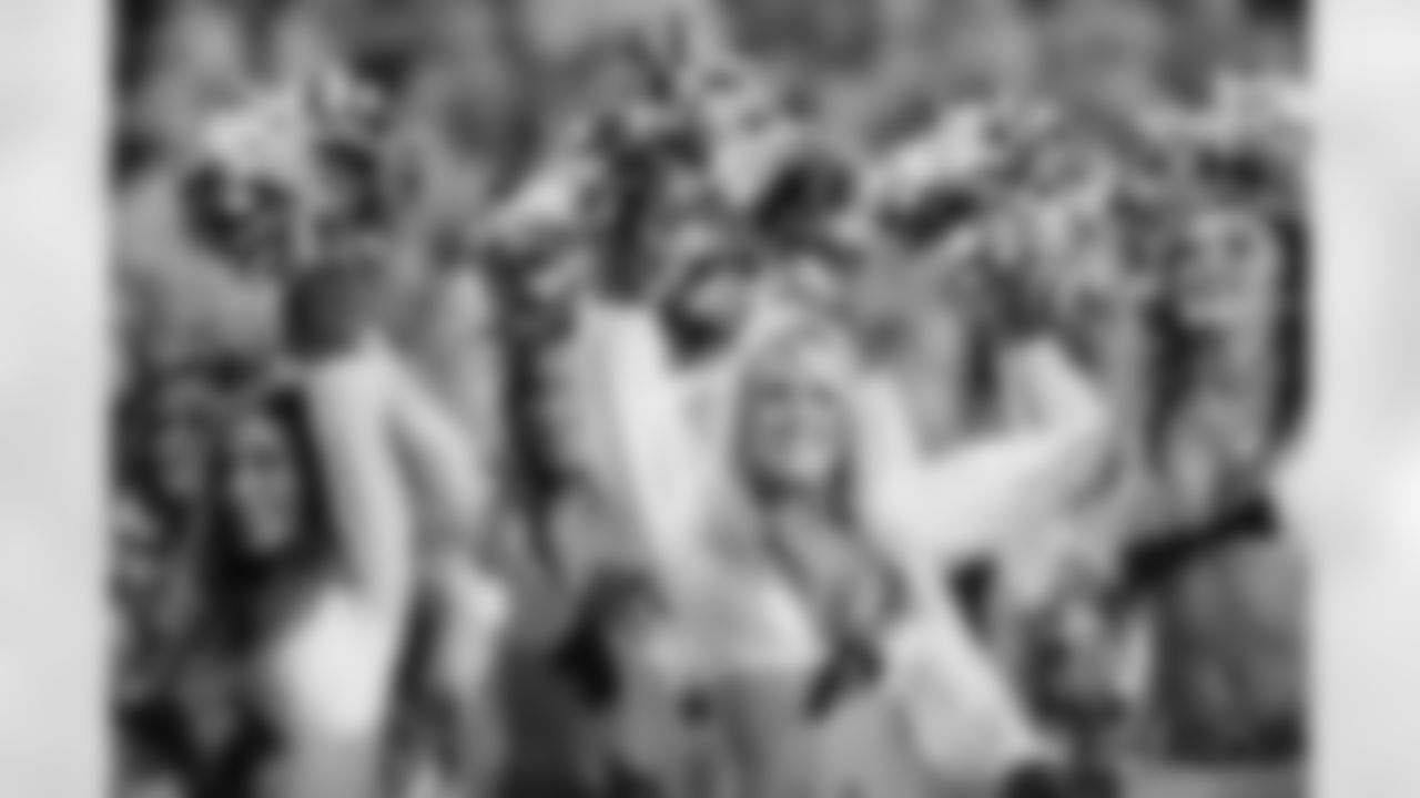 [December 22, 2002]: Seahawks 30 – Rams 10St. Louis Rams running back Marshall Faulk tries to hurdle Seahawks defenders to gain more yardage on Sunday, Dec. 22, 2002, at Seattle Seahawks Stadium. Bringing down Faulk are Seattle defenders Antonio Cochran, bottom, Chad Eaton (90) and Rocky Bernard (99). Seattle beat St. Louis, 30-10. (AP Photo/Jim Bryant)