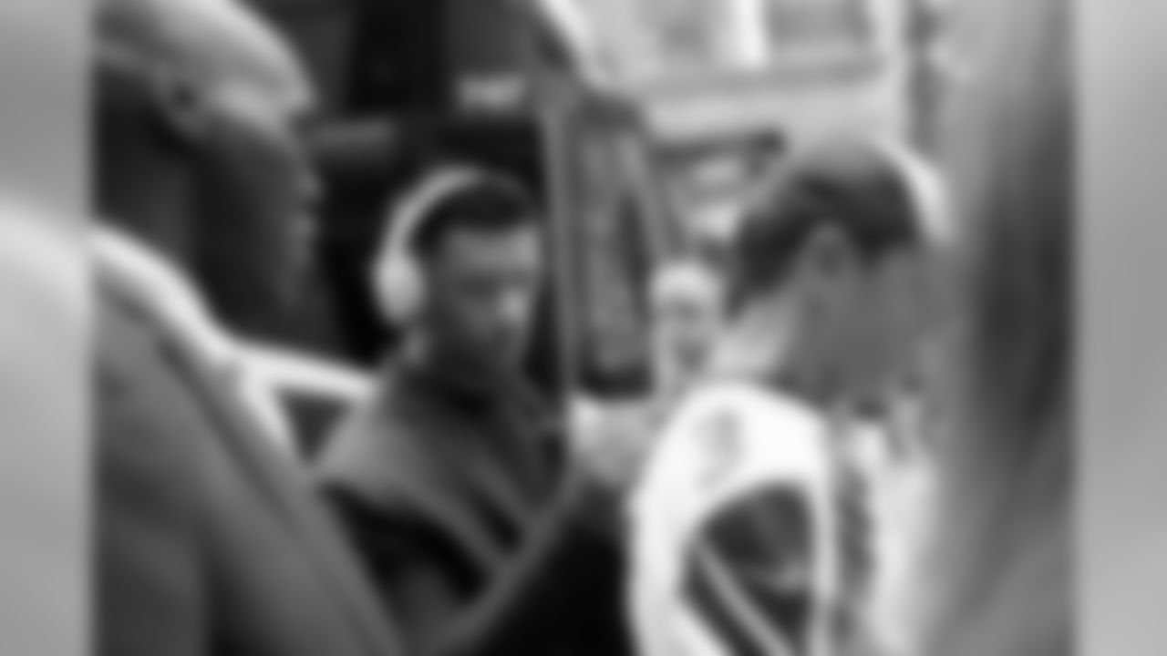 Seahawks quarterback Russell Wilson pauses to sign autographs before boarding the team buses for the ride to Soldier Field for Monday Night Football.