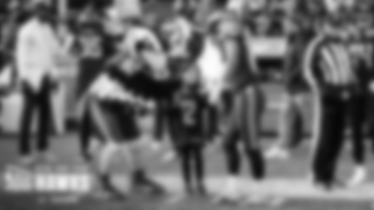Seahawks mascot blitz introduces the young fan honored as the Virginia Mason Playmaker to receiver Tyler Lockett before the game.