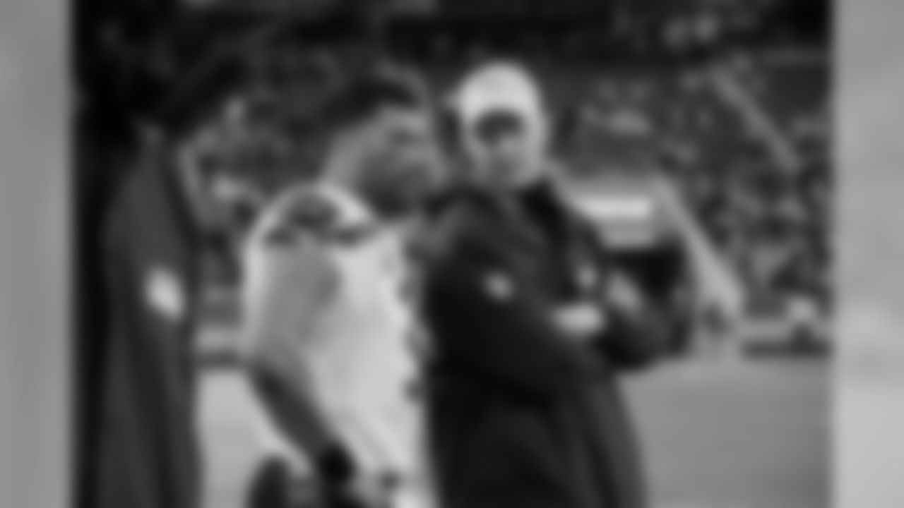 Near the end of the game, offensive coordinator and quarterback Russell Wilson chat on the sidelines.