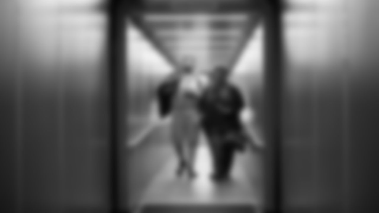 Seahawks first round draft pick Charles Cross and his mother walk down the jetway as they board a flight to Seattle on Friday morning.