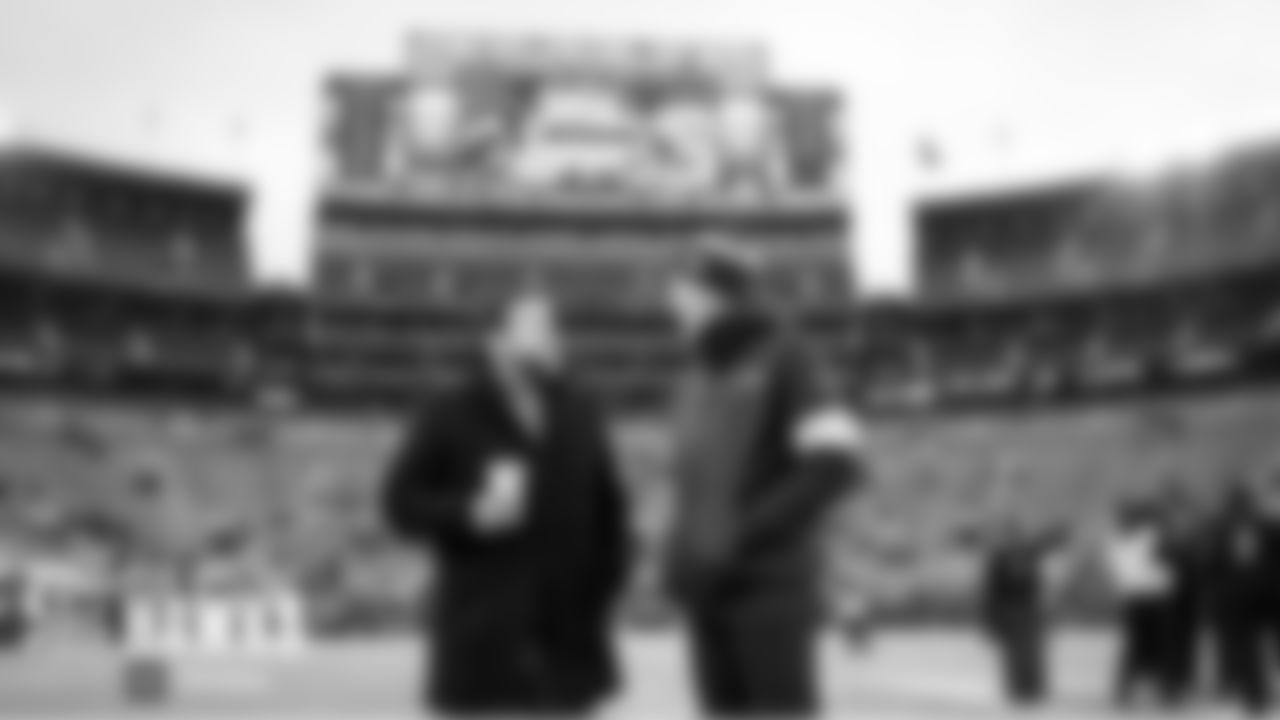 Seahawks general manager John Schneider and Pete Carroll talk on the field during early pregame.