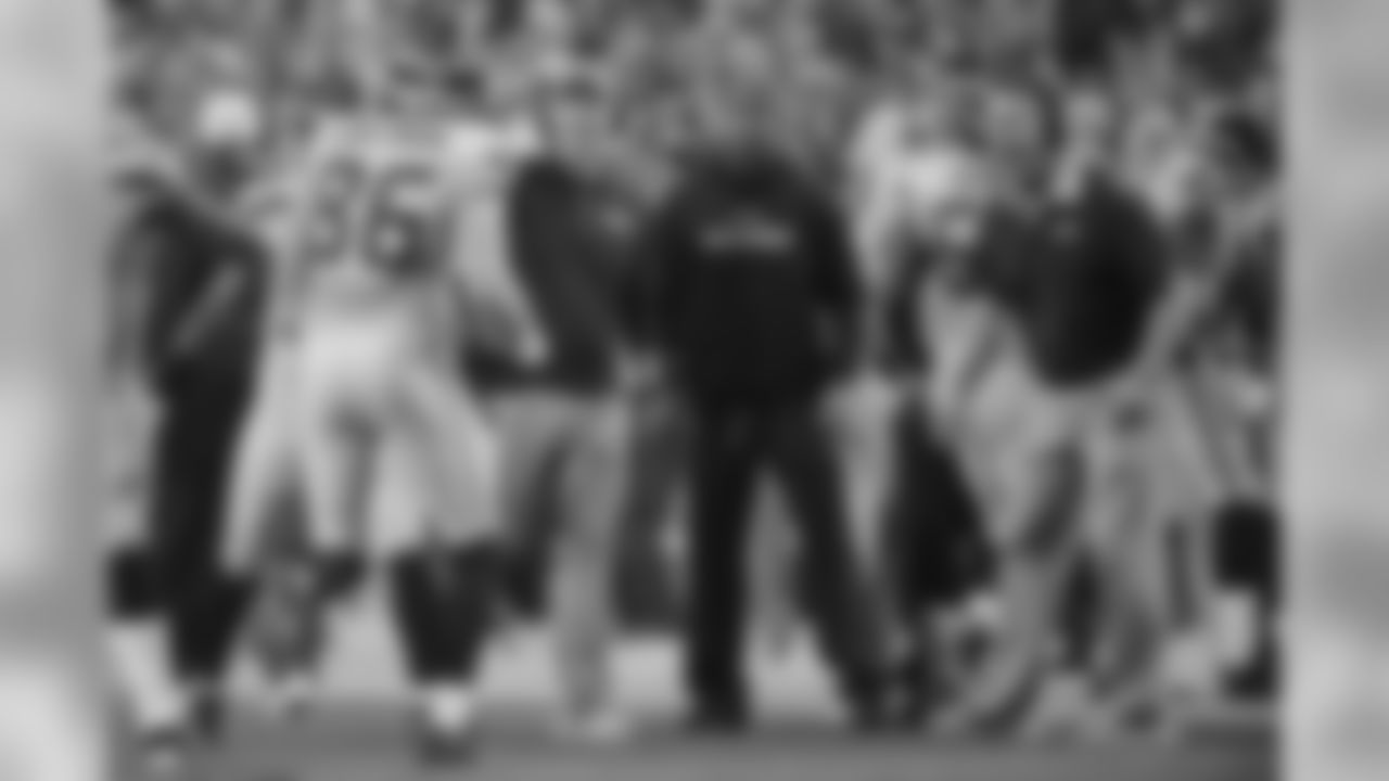 Offensive coordinator Darrell Bevell and tight ends coach Pat McPherson wait to greet Chase Coffman after his touchdown in the second quarter.