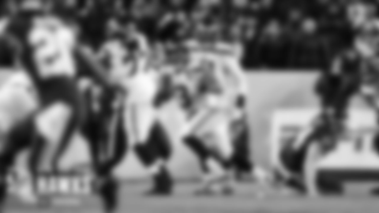 Seahawks quarterback Russell Wilson looks downfield as he moves from the pocket.