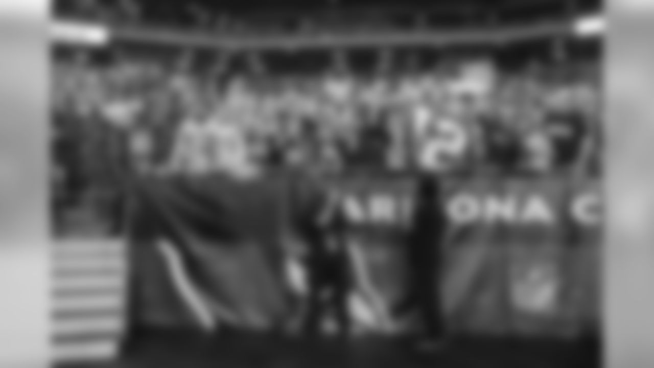 As is a common site at road games in Arizona, 12s showed out loud and proud and were unwavering in their support. Two Arizona employees cover their faces and turn away from the camera as hundreds of fans in the section behind them roar in the fourth quarter.