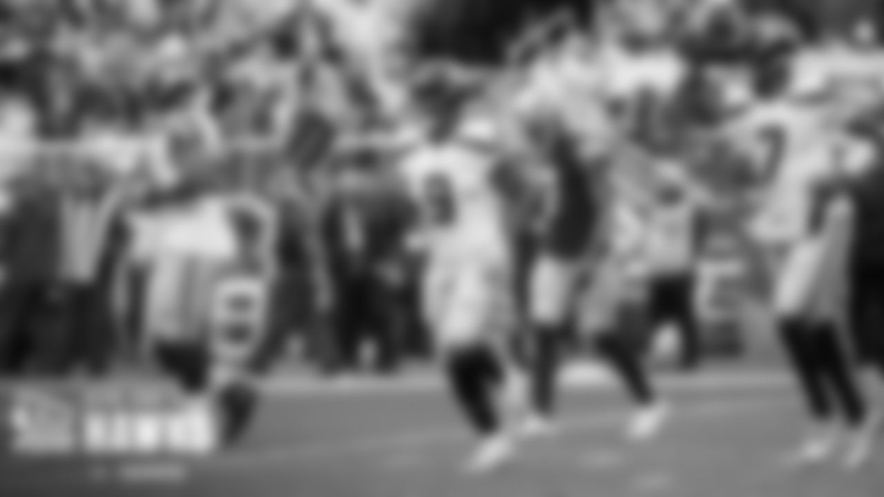 Running back Kenneth Walker III returns to the sidlines after scoring Seattle's first touchdown.