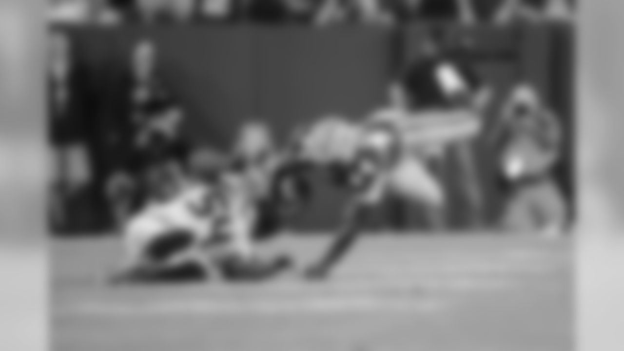 Seattle linebacker K.J. Wright upends Green Bay's James Starks.