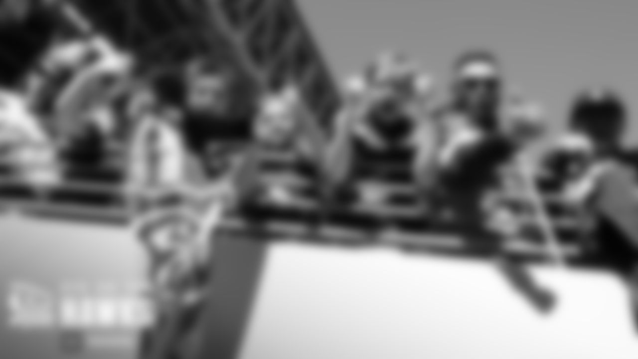 Fans along the railing near the Seahawks tunnel cheer the players as they enter the field.