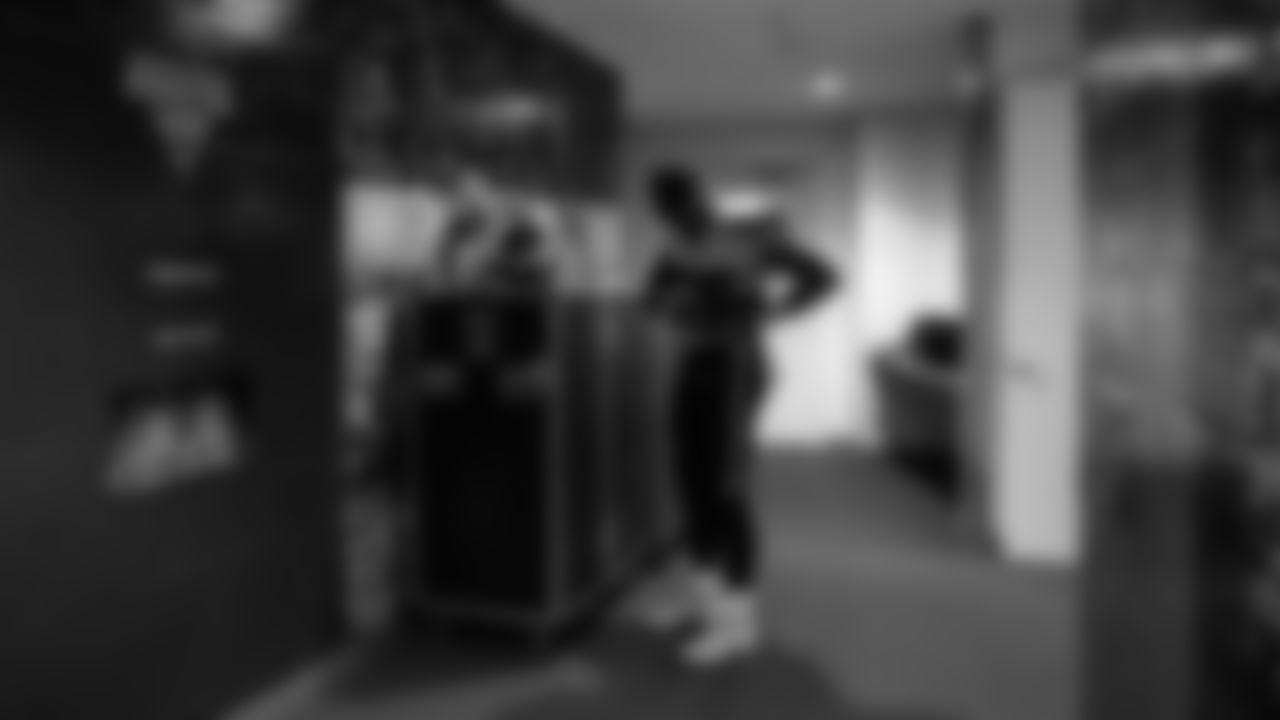 Seahawks tight end Noah Fant makes last-minute adjustiments to his uniform before leaving the locker room.