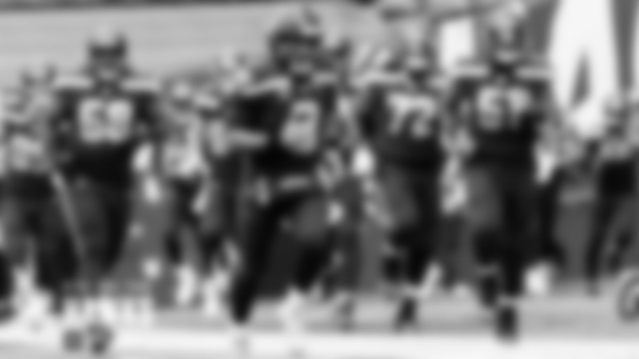 Seahawks quarterback Russell Wilson leads the team onto the field.