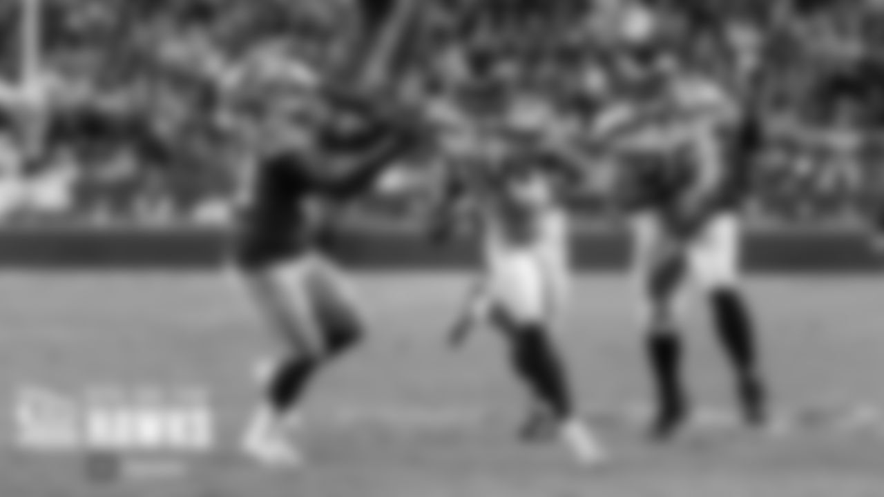 Seattle's DK Metcalf stiff-arms San FranciscoÕs Dre Greenlaw and heads upfield.