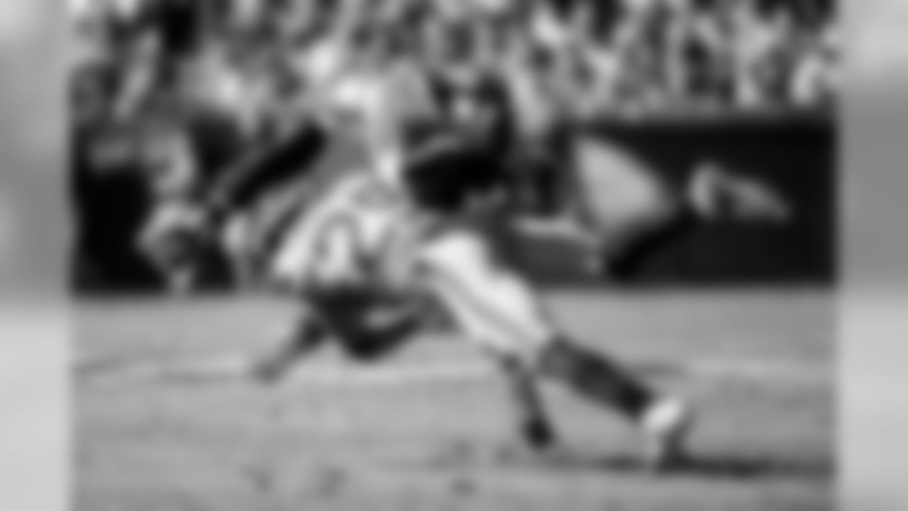 Safety Earl Thomas makes an acrobatic tackle of Carolina's Cam Newton.