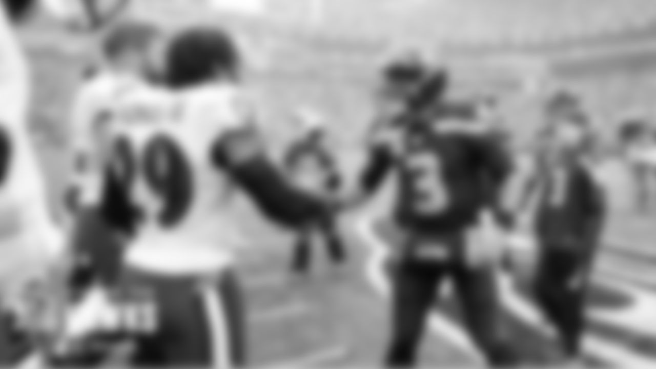 Seahawks quarterback Russell Wilson greets former teammate Earl Thomas as the captains meet at midfield for the opening coin toss.