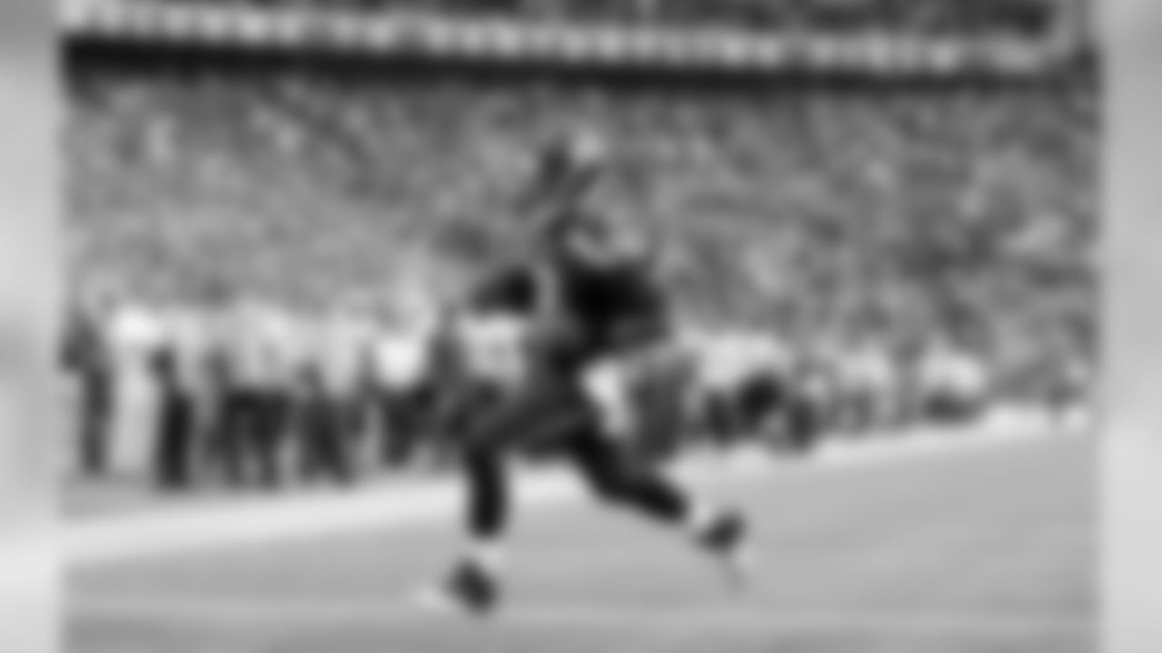Seattle Seahawks quarterback Russell Wilson rushes for a touchdown against the San Diego Chargers in the first half of a preseason NFL football game, Friday, Aug. 15, 2014, in Seattle. (AP Photo/Stephen Brashear)