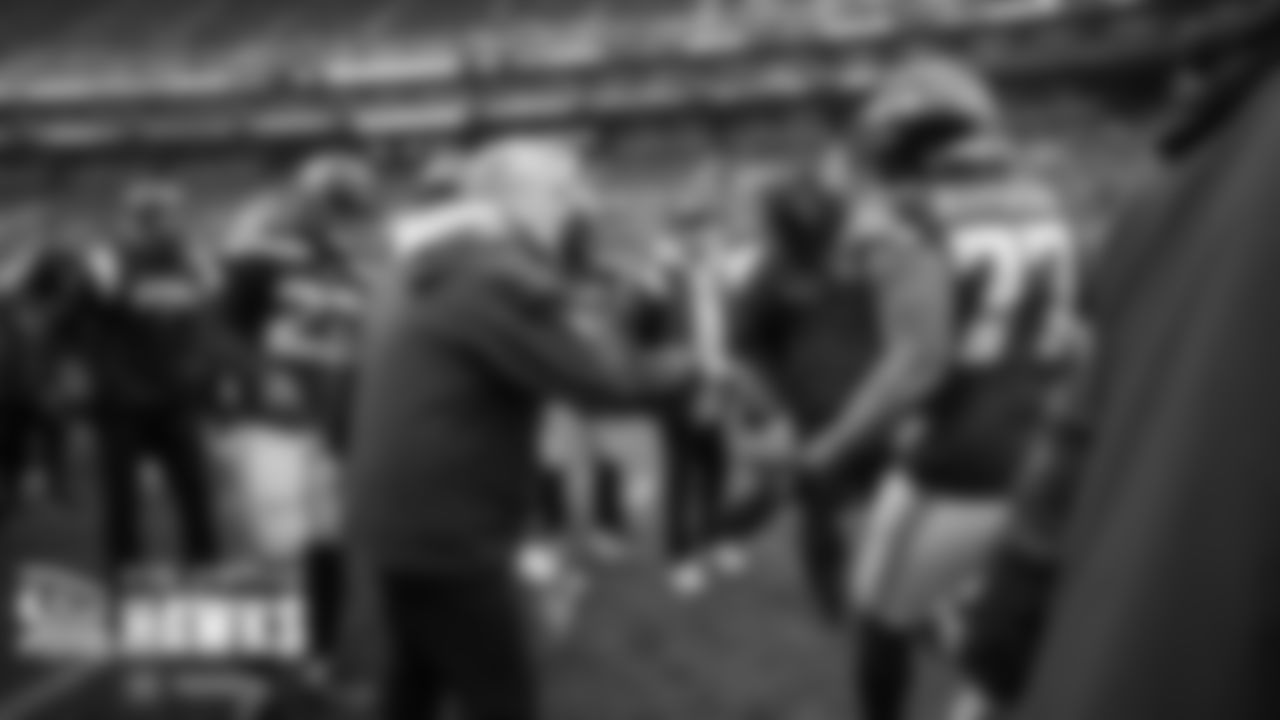 Seahawks head coach Pete Carroll greets his team as the enter the field for pregame warmups.