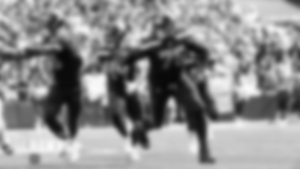 Seahawks Jaron Brown, Nick Bellore and Duane Brown lead the way for running back Rashaad Penny.