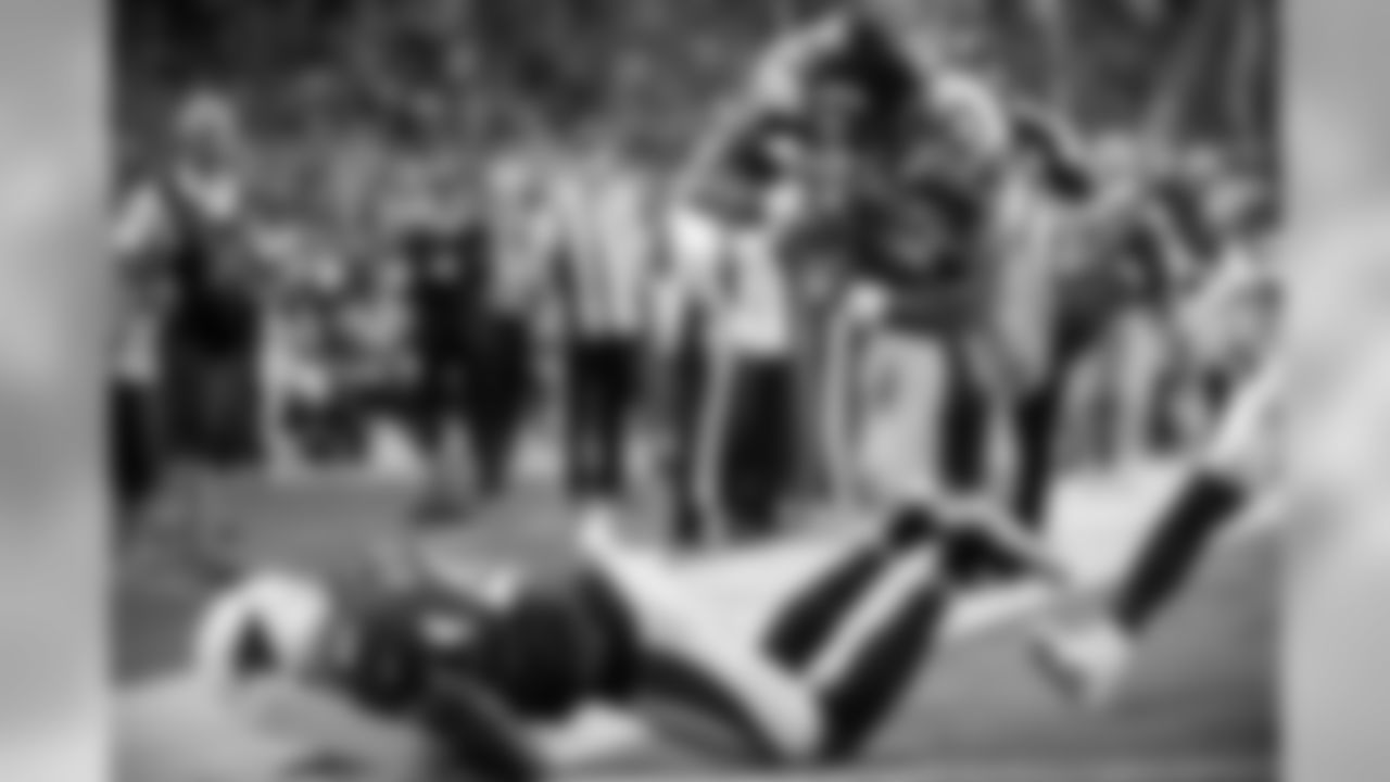 Running back Mike Davis dives into the end zone with Seattle's first touchdown after barreling through Arizona defender Antoine Bethea.