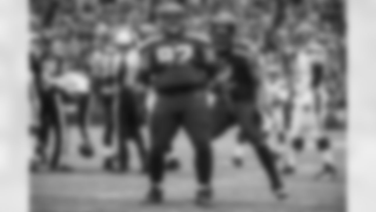 Seahawks defensive lineman Brandon Mebane reacts to his sack by breaking out his signature "belly roll" as teammate Michael Bennett joins the celebration.