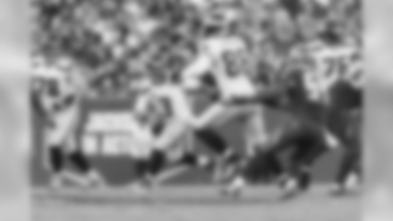 Quarterback Russell Wilson scrambles during the first half.