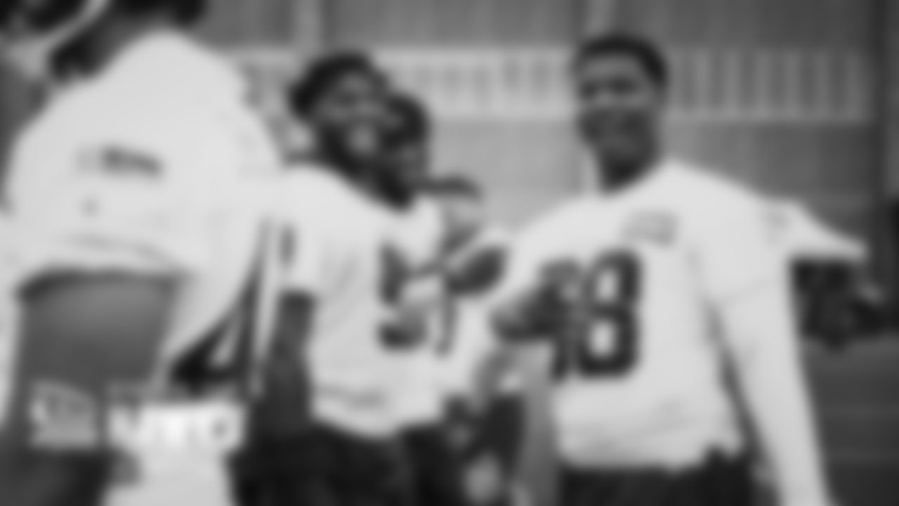 Seahawks defenders L.J. Collier, Darrell Taylor and Alton Robinson share a laugh during a break at minicamp practice.