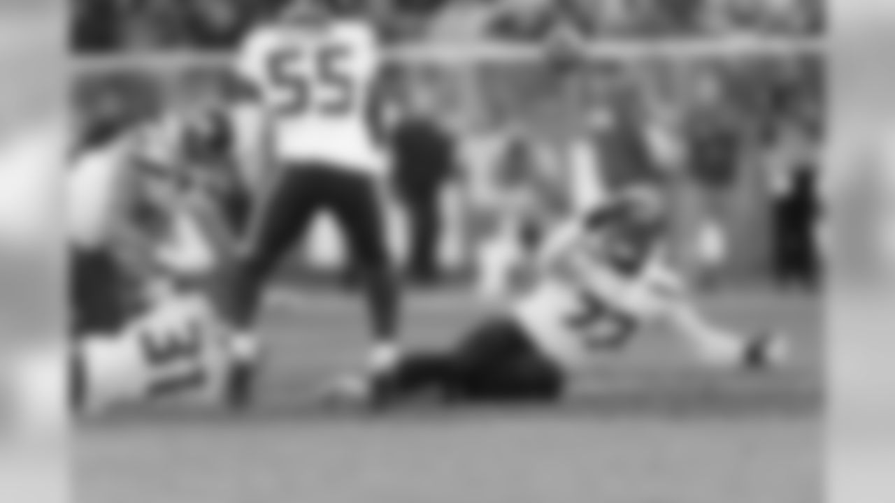 Ahtyba Rubin tries to the grab the fumble along with teammates Frank Clark, Cassius Marsh and Kam Chancellor.