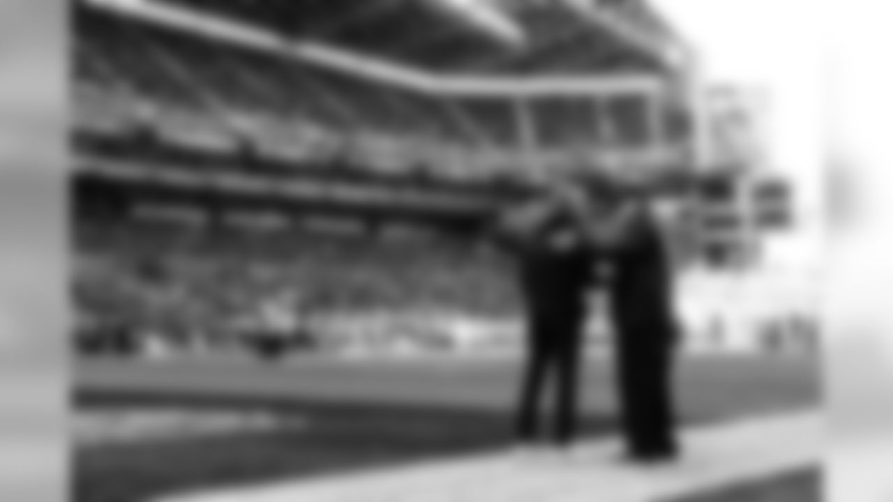 Seahawks head coach Pete Carroll and team owner Paul Allen shake hands on the field before the game.