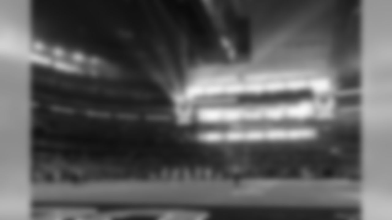 The late winter sun streams through the end zone windows at AT&T Stadium.