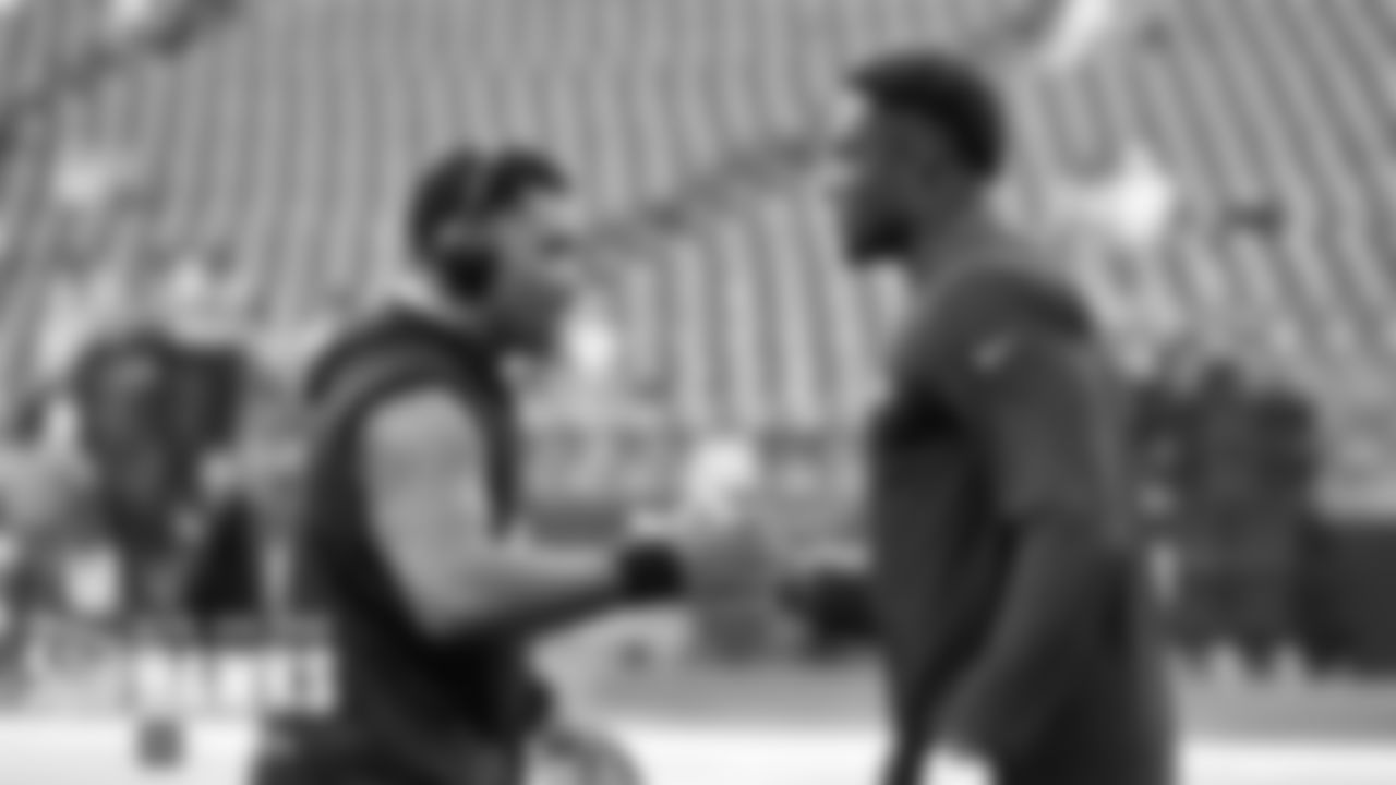 Russell Wilson and DK Metcalf shake hands after their early pregame warmups.
