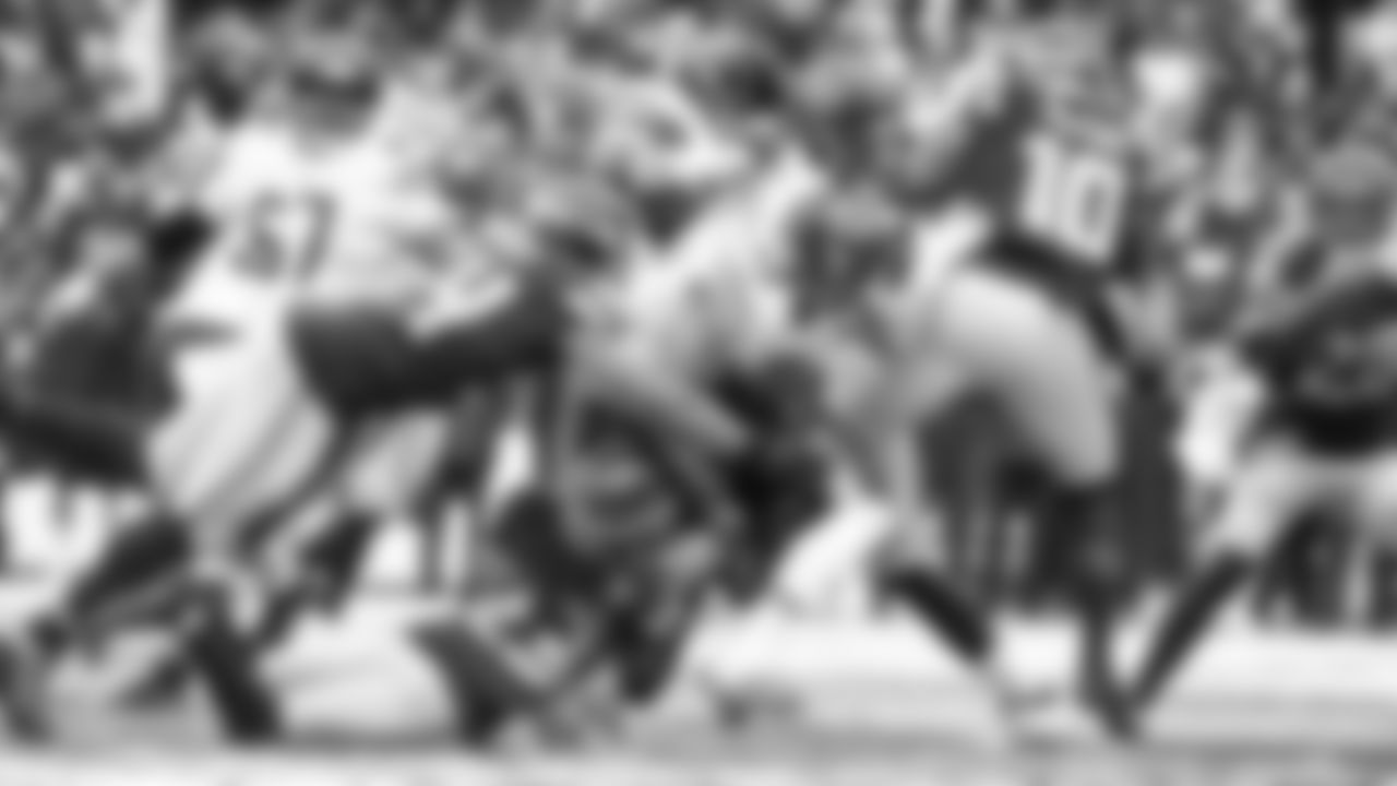 A gang of Seahawks defenders including Bobby Wagner, Sidney Jones and Benson Mayowa combine on a tackle.