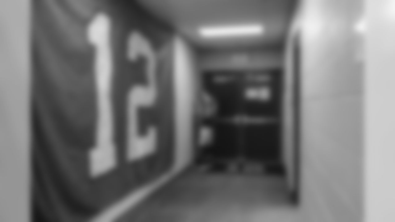 Receiver Doug Baldwin finds a quiet corner to himself in the locker room before the game. The large 12 flag on the wall was signed by fans in Seattle on Friday at Blue Friday rallies then sent with the team on the charter.