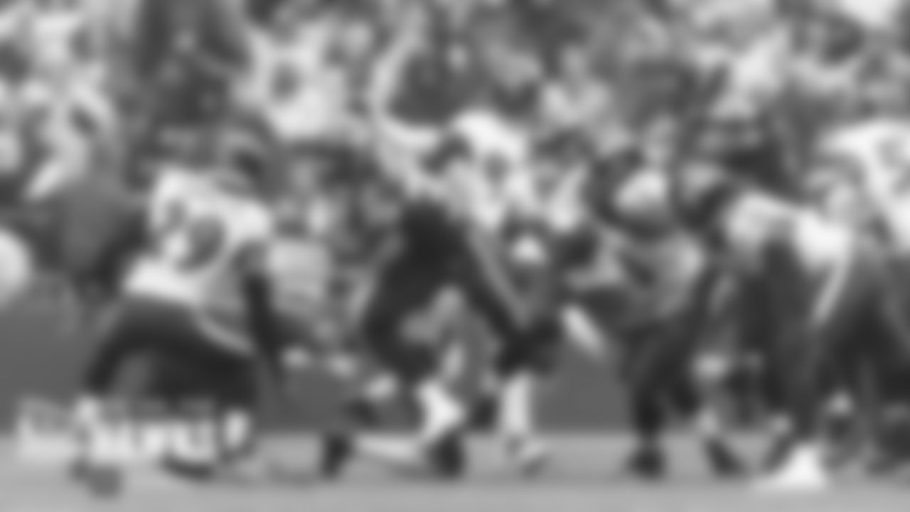 Seahawks running back Chris Carson barges through the line for gain in the first quarter.