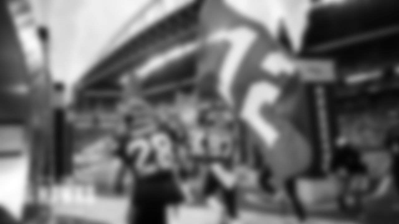 Ugo Amadi carries the 12 flag out of the tunnel as the Seahawks are introduced.